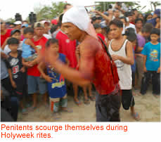 Penitents scourge themselves during Holyweek rites