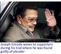 Joseph Estrada waves to supporters during his trial where he was found guilty of plunder