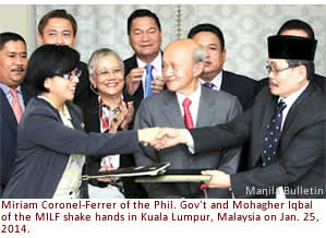 Miriam Coronel-Ferrer of the Phil. Gov't and Mohagher Iqbal of the MILF shake hands in Kuala Lumpur, Malaysia on Jan. 25, 2014