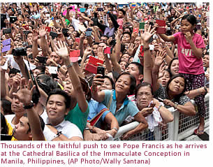 Thousands of the faithful push to see Pope Francis as he arrives at the Cathedral Basilica of the Immaculate Conception in Manila, Philippines,