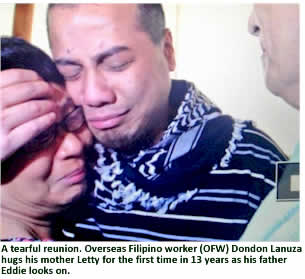 A tearful reunion. Overseas Filipino worker (OFW) Dondon Lanuza hugs his mother Letty for the first time in 13 years as his father Eddie looks on