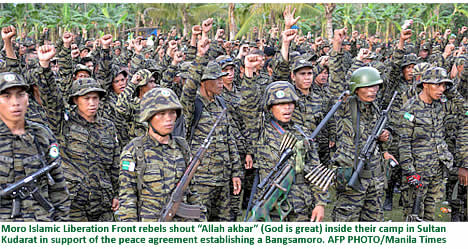 Moro Islamic Liberation Front rebels shout Allah akbar (God is great) inside their camp in Sultan Kudarat in support of the peace agreement establishing a Bangsamoro