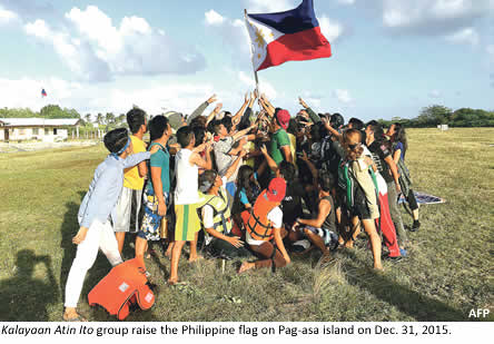 Kalayaan Atin Ito group raise the Philippine flag on Pag-asa island on Dec. 31, 2015