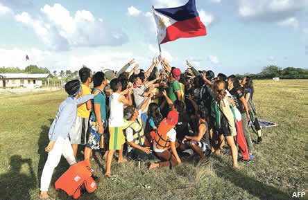 Kalayaan Atin Ito group raises the Philippine flag on Pag-asa island last Dec. 31, 2015